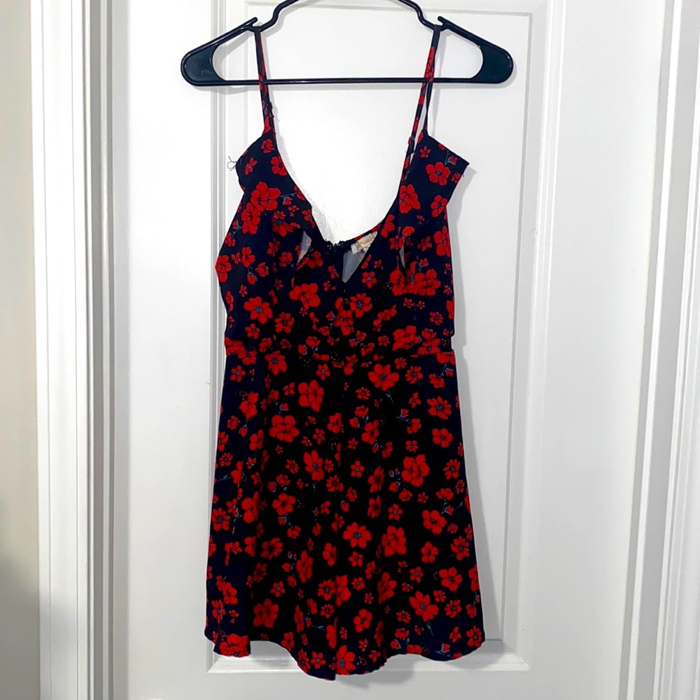 A Peach Size L Black Sleeveless Romper with Red Floral Design